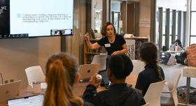 Professor Katie Dawson, director of Drama for Schools, leads students in a data analysis exercise at Ann Richards School for Young Women Leaders in Austin. Photo by Jessica Alexander.