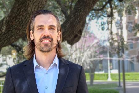 Smiling portrait of Brad Knox standing outside on campus
